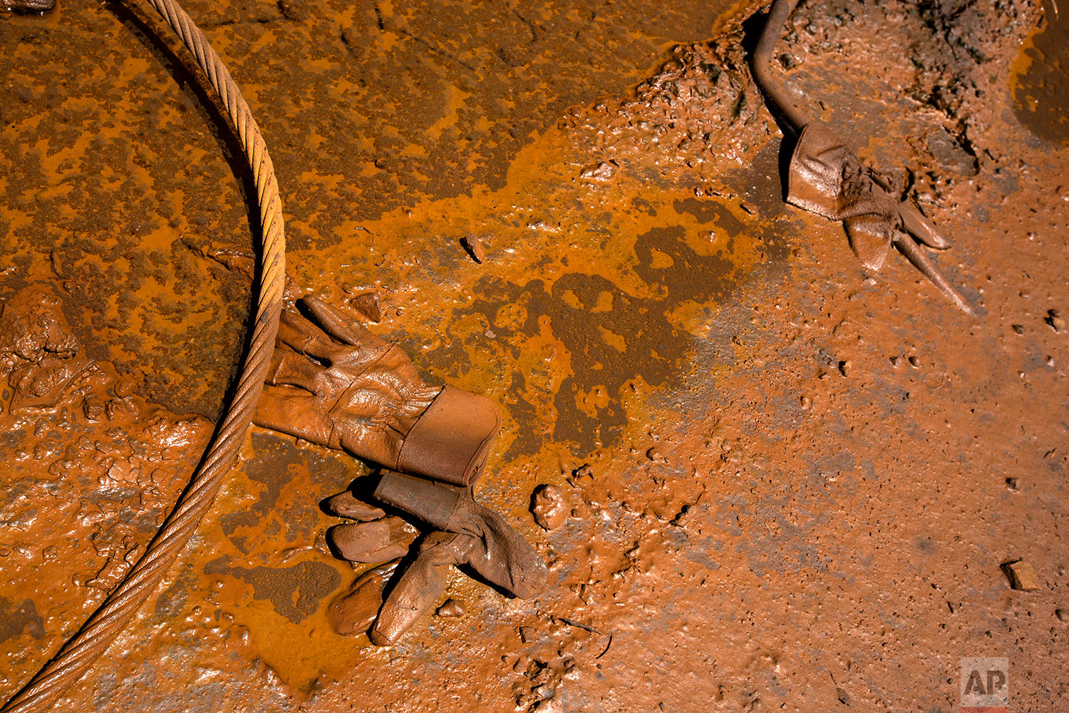  In this Nov. 1, 2017 photo, work gloves lay on a dirty floor at Ferrominera Orinoco, in Ciudad Guayana, Bolivar state, Venezuela. When these steel plants first opened workers from all over the country poured into a new city dreamed up by planners fr