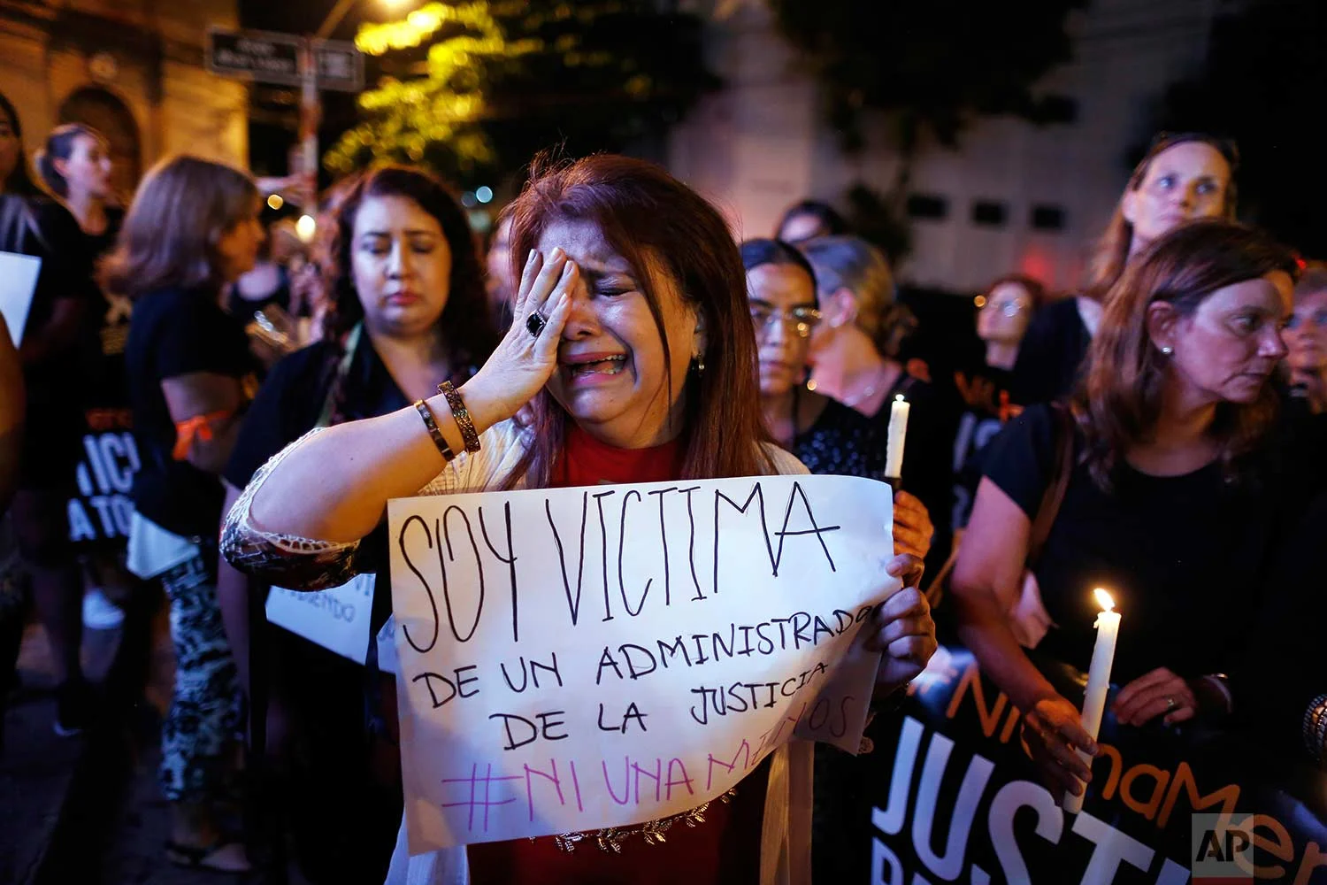 The ex-wife of a judge who said she was attacked by him, cries as she joins a protest against femicides in Asuncion, Paraguay, Thursday, Dec. 21, 2017. (AP Photo/Jorge Saenz)
