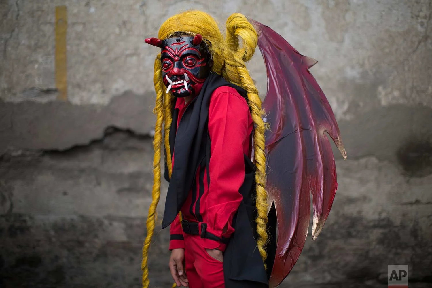 Bryan Gonzalez, 14, poses for a portrait in his devil costume at a procession symbolizing the fight between good and evil that celebrates the Virgin of the Immaculate Conception in Ciudad Vieja, Guatemala, Thursday, Dec. 7, 2017. (AP Photo/Luis Soto)
