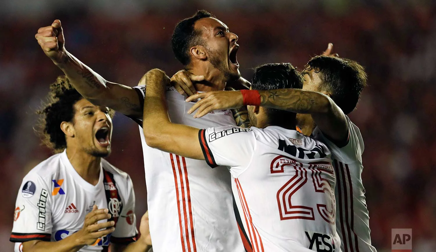 In this Wednesday, Dec. 6, 2017 photo, Brazil's Flamengo Rever, center, celebrates his goal against Argentina's Independiente during a Copa Sudamericana first leg, final soccer match in Buenos Aires, Argentina. Independiente went on to win the opening leg 2-1. (AP Photo/Natacha Pisarenko)