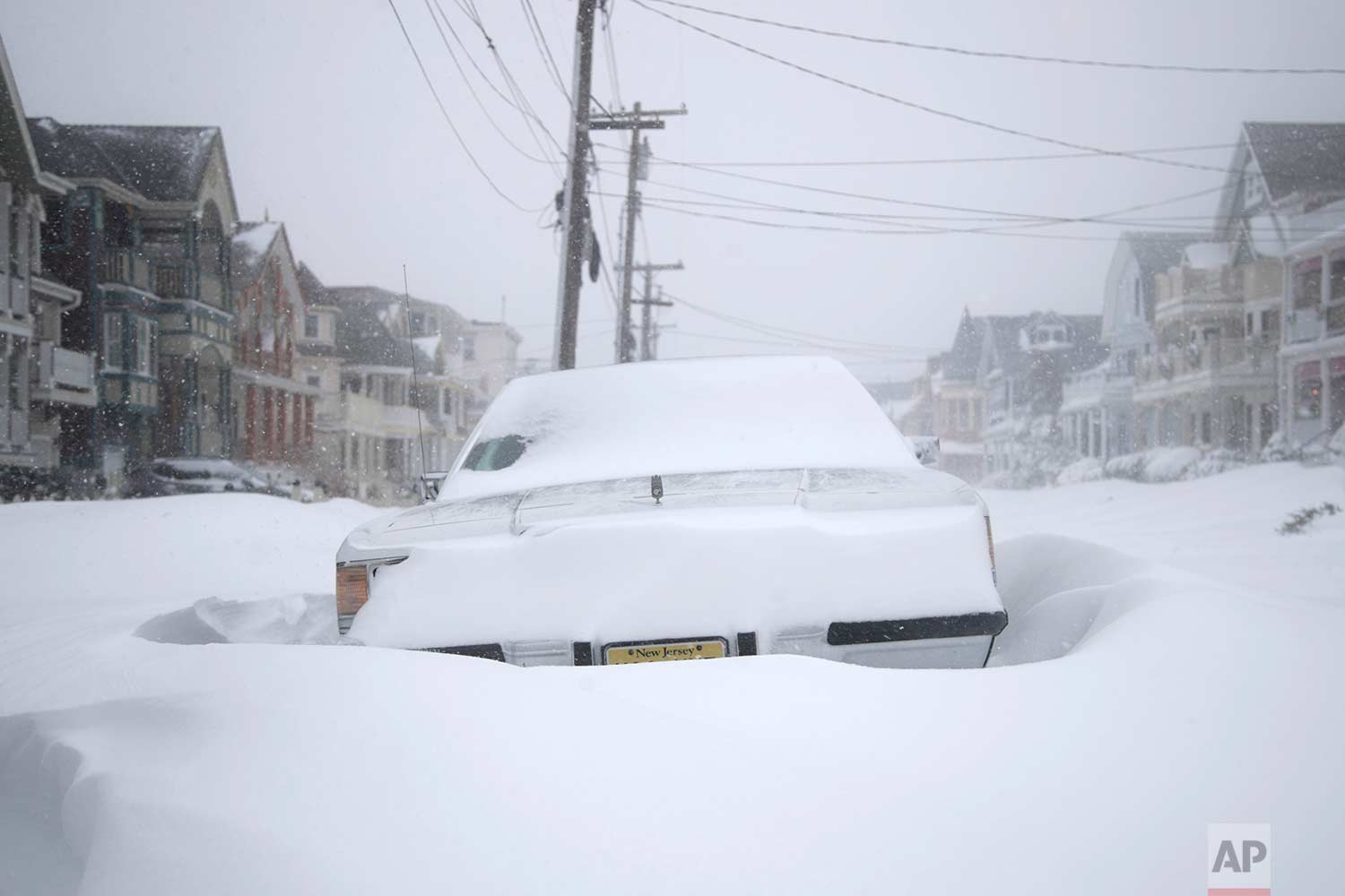  A vehicle parked on Abbott Avenue is engulfed by snowdrifts during a snowstorm that hit the New Jersey Shore, Thursday, Jan. 4, 2018, in Ocean Grove, N.J. (AP Photo/Julio Cortez) 