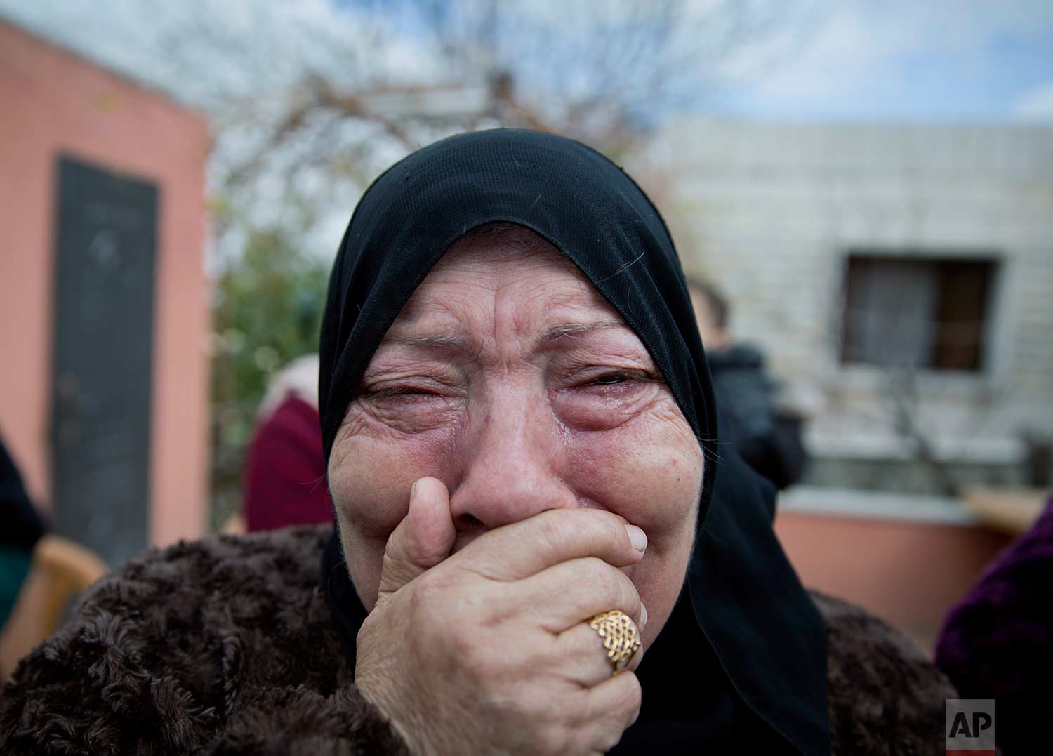  A mourner cries while taking a farewell look at the body of Musab Tamemi, 17, who was killed in clashes with the Israeli army the previous day, during his funeral in the West Bank village of Deir Nizam, near Ramallah, Thursday, Jan. 4, 2018. Israel'