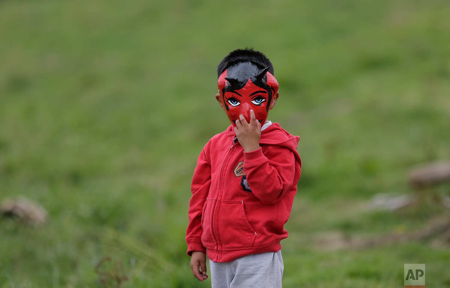  A boy wearing a devil mask participates in the traditional New Year's festival known as "La Diablada", in Pillaro, Ecuador, Friday, Jan. 5, 2018. (AP Photo/Dolores Ochoa) 