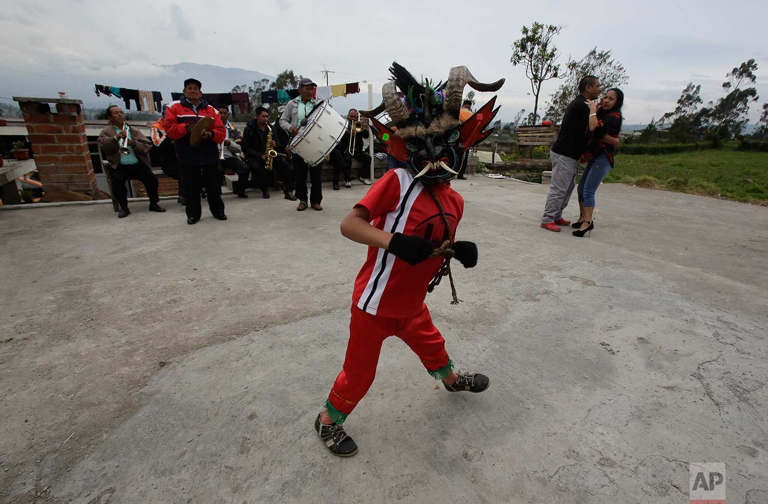  A man wearing a devil mask dances during the traditional New Year's festival known as "La Diablada", in Pillaro, Ecuador, Friday, Jan. 5, 2018. (AP Photo/Dolores Ochoa) 