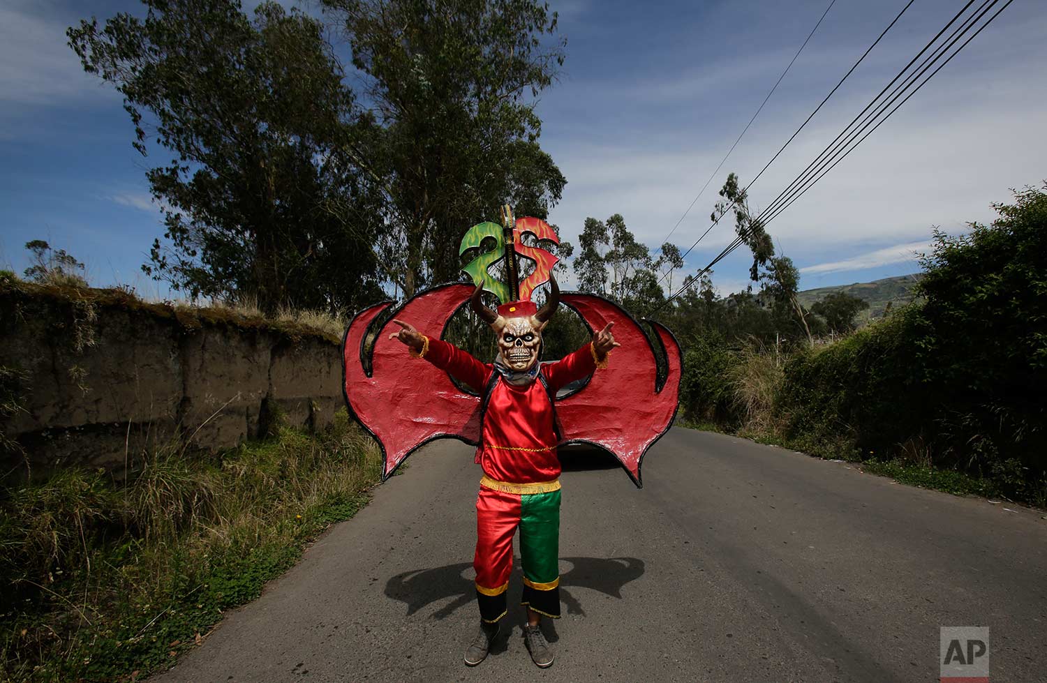  Dressed for the traditional New Year's festival known as "La Diablada", a participant strikes a pose in Pillaro, Ecuador, Friday, Jan. 5, 2018. (AP Photo/Dolores Ochoa) 