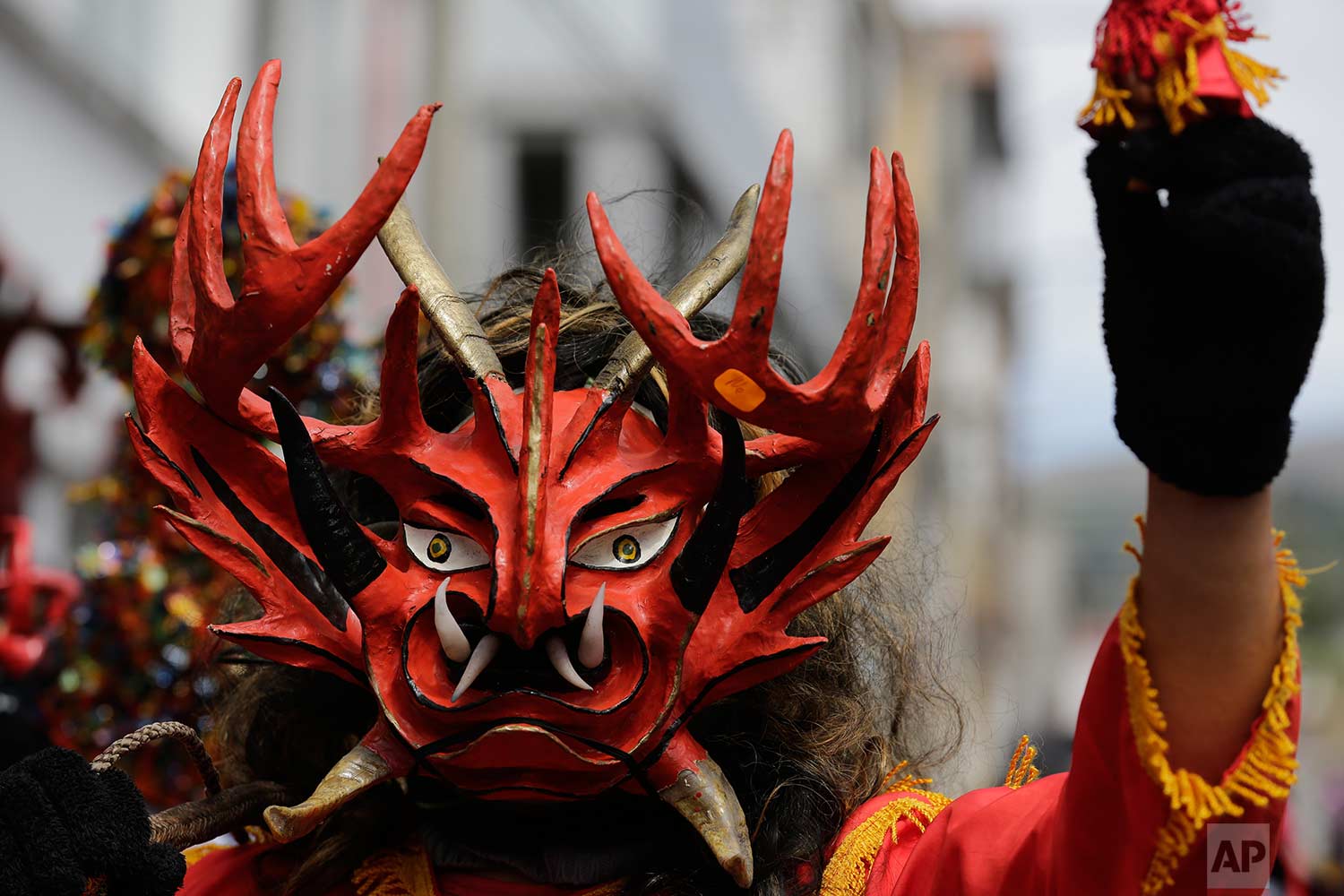  A man wearing a devil mask takes part in a parade as part of the traditional New Year's festival known as "La Diablada", in Pillaro, Ecuador, Friday, Jan. 5, 2018. (AP Photo/Dolores Ochoa) 