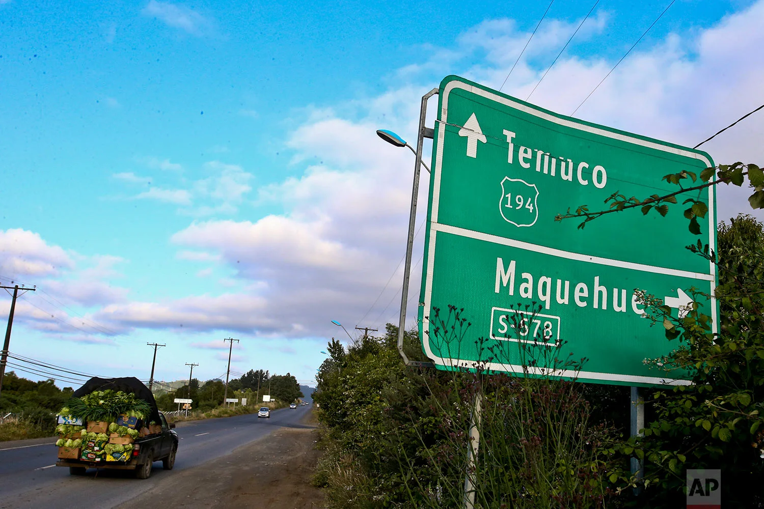 In this Monday, Jan. 8, 2018 photo, a truck filled with lettuce drives past the Maquehue Air Base, in Temuco, Chile. (AP Photo/Esteban Felix) | See these photos on AP Images