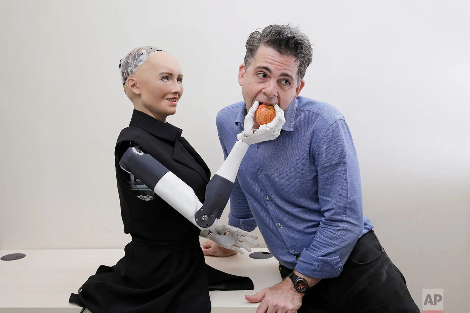 In this Sept. 28, 2017, photo, David Hanson, the founder of Hanson Robotics, poses with his company's flagship robot Sophia, a lifelike robot powered by artificial intelligence in Hong Kong. (AP Photo/Kin Cheung) | See these photos on AP Images