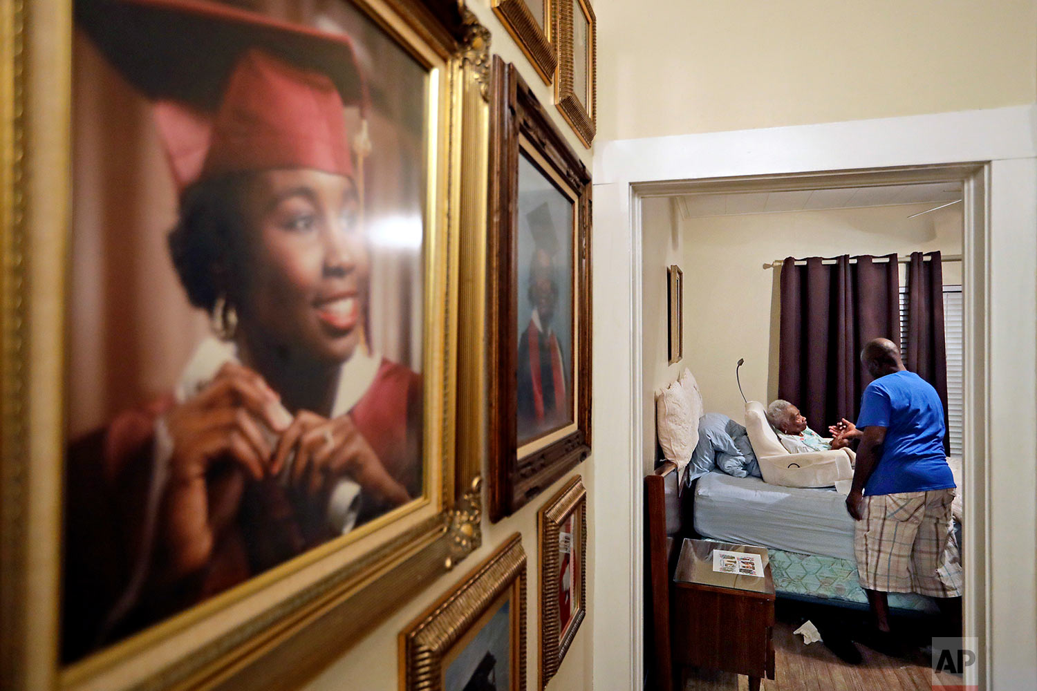  Greg Gunner, right, checks in on his grandmother Mabel Bishop, 99, stricken with Alzheimer's disease, in their home that was damaged by Hurricane Harvey in Port Arthur, Texas, Tuesday, Sept. 26, 2017. Gunner carried his grandmother out of the house 