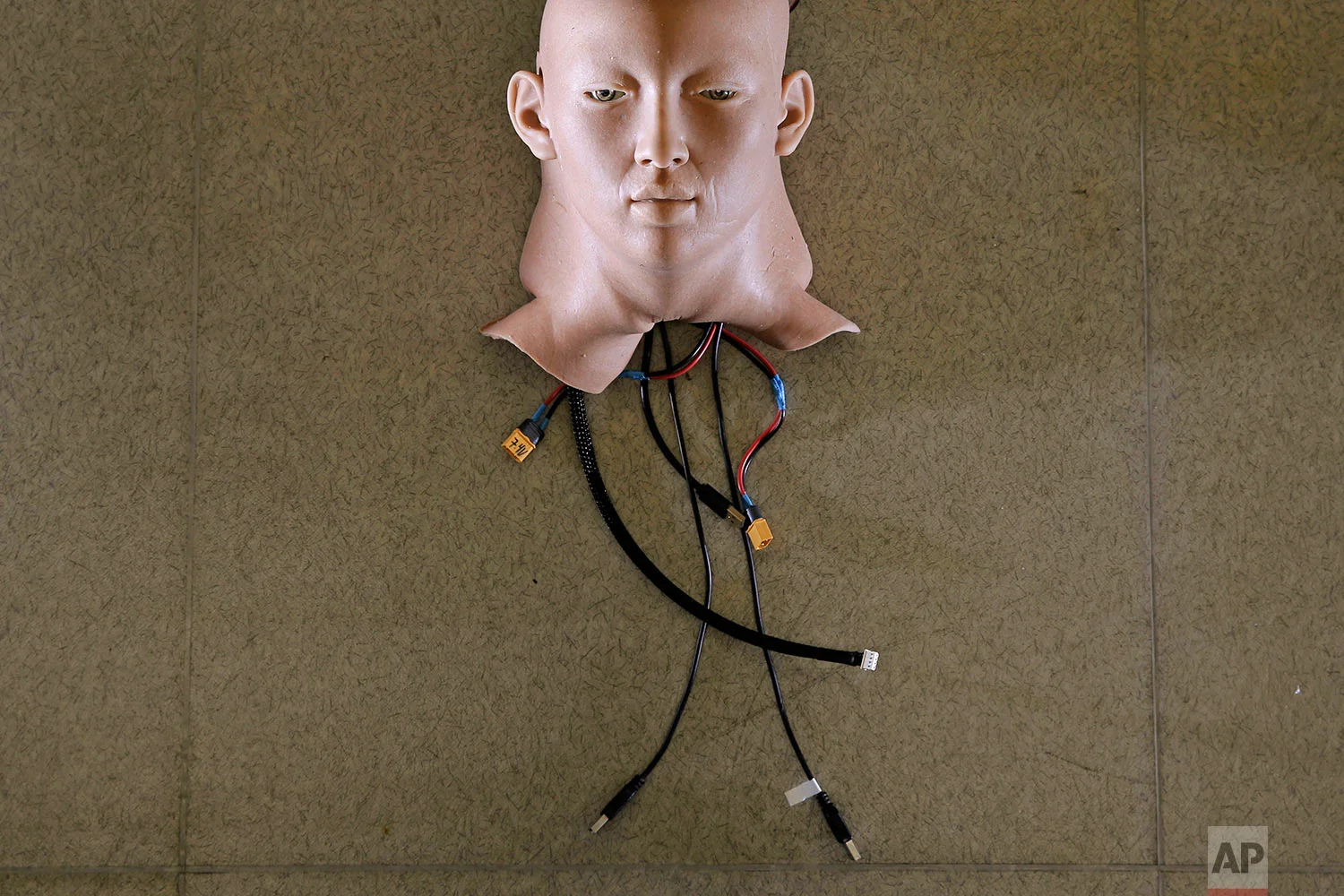 In this Sept. 28, 2017 photo, a robot head is covered by the Hanson Robotics's skin, which is a nanotech material dubbed “Frubber”, that has a texture somewhere between bouncy and squishy, in Hong Kong. Hanson Robotics is a Hong Kong-based startup working on bringing humanoid robots to the marketplace. (AP Photo/Kin Cheung) | See these photos on AP Images 