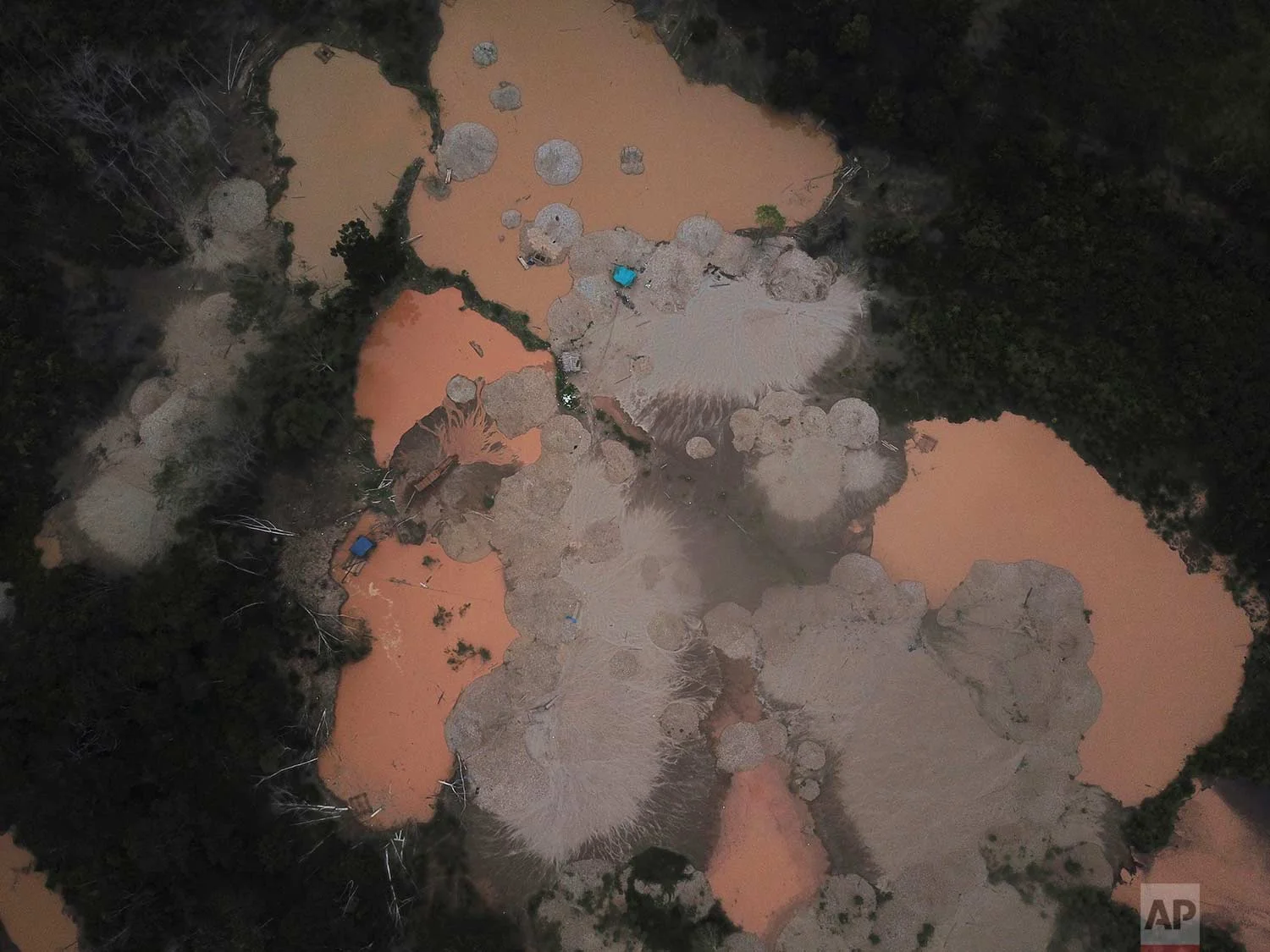 This Jan. 13, 2018 photo shows a deforested area damaged by illegal gold mining and dotted with blue tarps in Boca Colorado, part of Peru’s Madre de Dios region in the Amazon. (AP Photo/Rodrigo Abd) | See these photos on AP Images