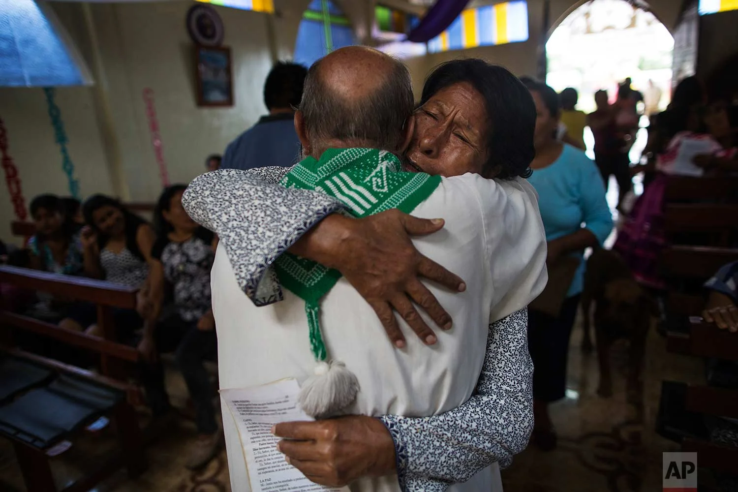 In this Jan. 14, 2018 photo, parishioner Lucero Fatima Cusi embraces Father Pablo Zabala, better known as Padre Pablo, during his last day as parish priest in Boca Colorado, part of Peru’s Madre de Dios region. (AP Photo/Rodrigo Abd) | See these photos on AP Images