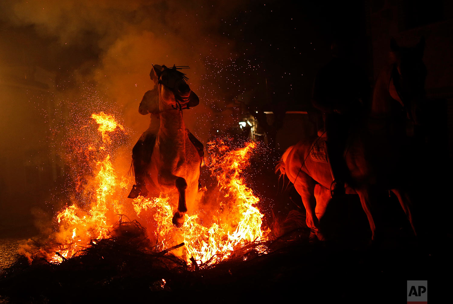  A man rides a horse through a bonfire as part of a ritual in honor of Saint Anthony the Abbot in San Bartolome de Pinares, Spain, Tuesday, Jan. 16, 2018. (AP Photo/Francisco Seco)&nbsp;|&nbsp; See these photos on AP Images  