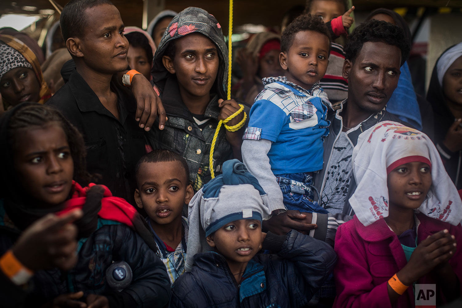  In this Friday, Jan. 19, 2018 photo Sub-Saharan refugees and migrants look to the Italian authorities from aboard the Spanish NGO Proactiva Open Arms rescue vessel, at the port of Pozzallo, in Sicily, Italy. (AP Photo/Santi Palacios)&nbsp;&nbsp; 