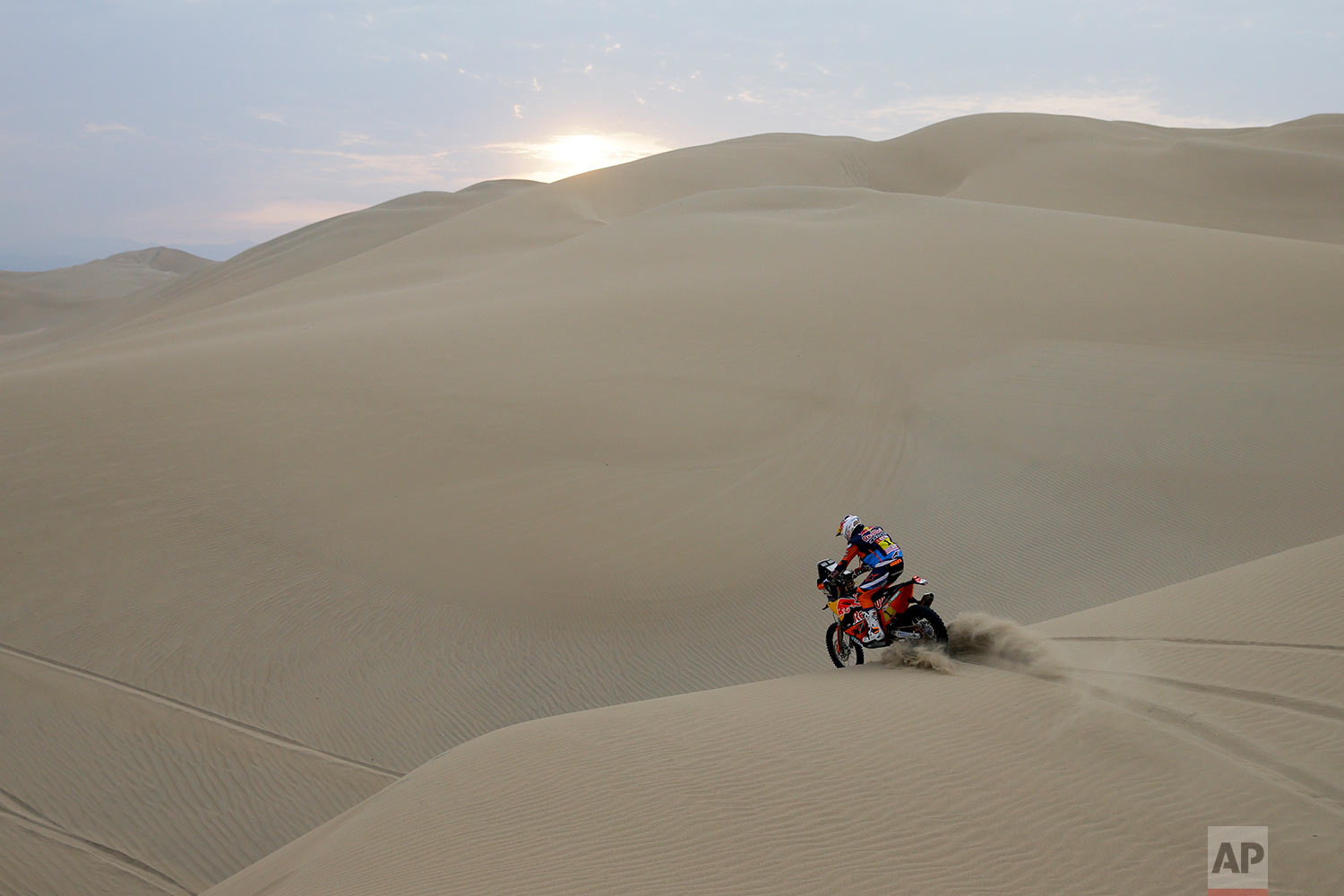  In this Monday, Jan. 8, 2018 photo, defending champion Sam Sunderland, of the United Kingdom, rides his KTM motorbike during the third stage of the Dakar Rally between Pisco and San Juan de Marcona, Peru. Sunderland was forced to abandon in the firs