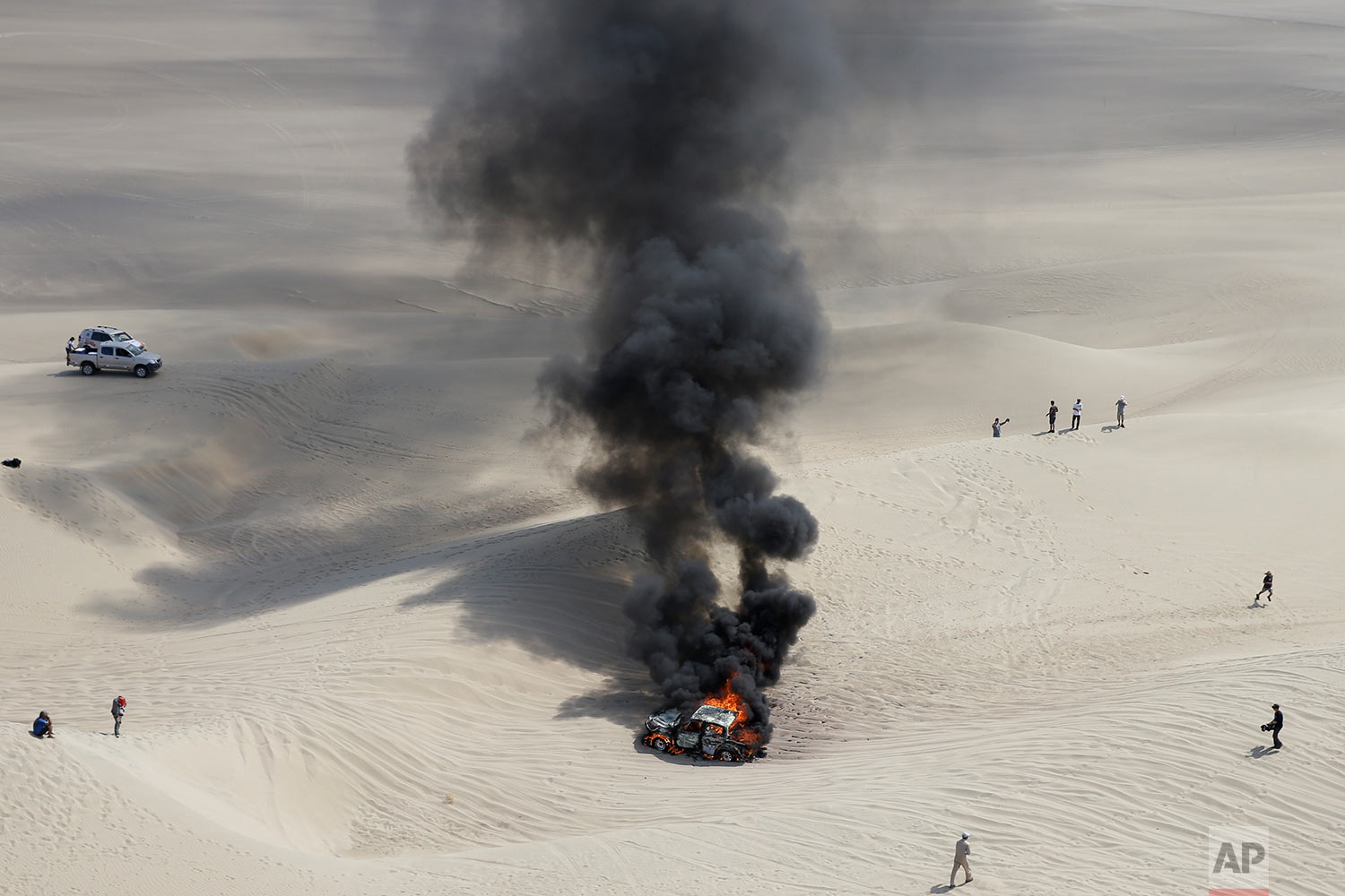  In this Monday, Jan. 8, 2018 photo, smoke rises from overheated Toyota, raced by driver Alicia Reina and co-driver Carlos Dante Pelayo, both Argentines, during the third stage of the Dakar Rally in Pisco, Peru. (AP Photo/Ricardo Mazalan)&nbsp; |&nbs