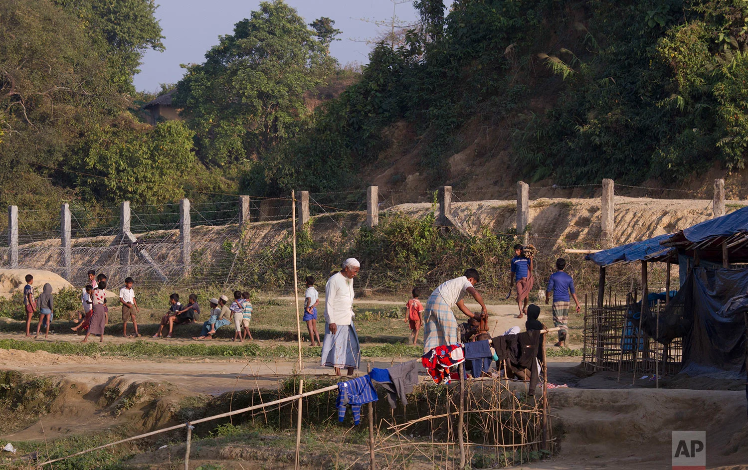 In this Tuesday, Jan. 23, 2018, photo, Rohingya refugees are seen next to the Bangladesh Myanmar border at Tumru, near Cox's Bazar, Bangladesh. (AP Photo/Manish Swarup) | See these photos on AP Images 