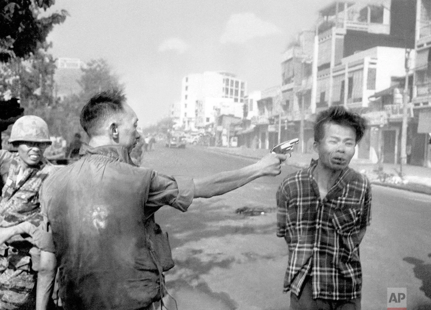 In this Feb. 1, 1968 photo, South Vietnamese Gen. Nguyen Ngoc Loan, chief of the National Police, fires his pistol into the head of suspected Viet Cong officer Nguyen Van Lem (also known as Bay Lop) on a Saigon street, early in the Tet Offensive. (AP Photo/Eddie Adams)