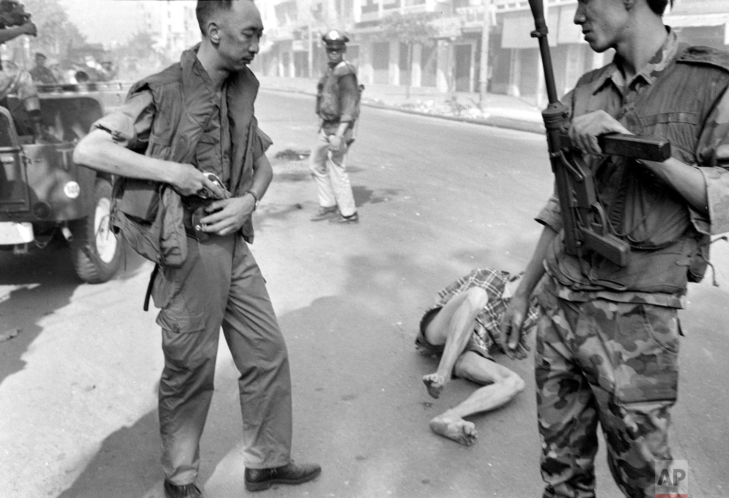  ** EDS NOTE: GRAPHIC CONTENT ** South Vietnamese Gen. Nguyen Ngoc Loan, chief of the national police, holsters his gun after executing suspected Viet Cong officer Nguyen Van Lem (also known as Bay Lop) whose body lies on a Saigon street Feb. 1, 1968