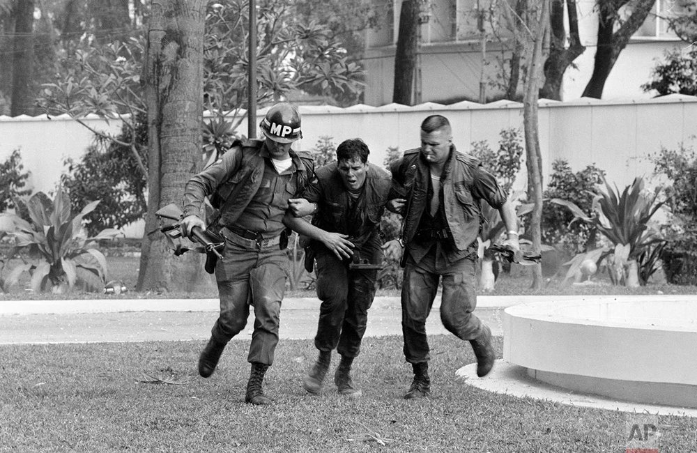  Two U.S. military policemen aid a wounded fellow MP during fighting in the U.S. Embassy compound in Saigon, Jan. 31, 1968, at the beginning of the Tet Offensive. A Viet Cong suicide squad seized control of part of the compound and held it for about 