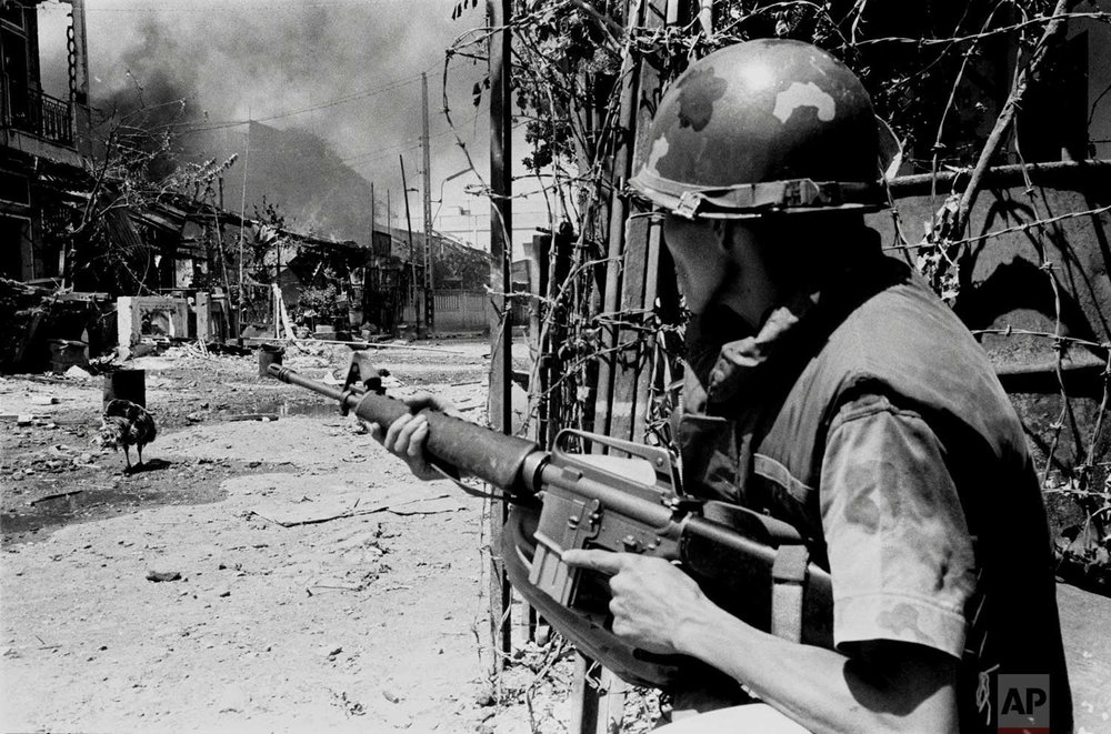  A South Vietnamese soldier takes a position on a Saigon street in early 1968, during the Tet Offensive. (AP Photo/Nick Ut) 