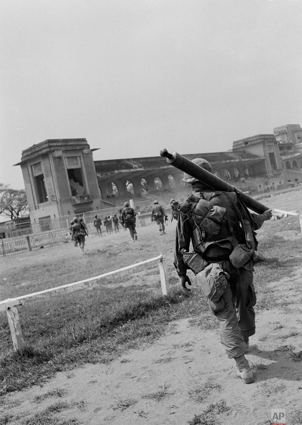  U.S. troops of the 199th Light Infantry Brigade march toward the grandstand after they were lifted to the Phu Tho racetrack in Saigon, South Vietnam, during the Tet Offensive, Feb. 9, 1968. They are there to help South Vietnamese force in routing th