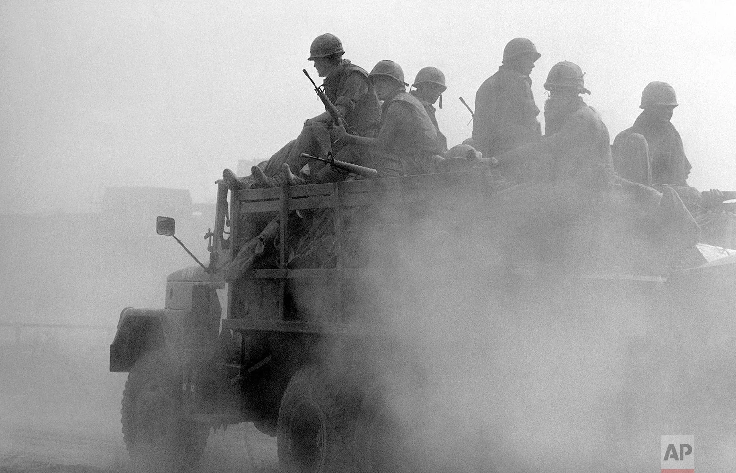 Specific date unknown. US soldiers ride in a truck at the Phu Tho racetrack in western Saigon, Feb. 8-26, 1968. US and S.Vietnamese troops set up a fire support base at the track to support troops engaged in mop-up operations throughout the city during the Tet Offensive. (AP Photo/Eddie Adams)