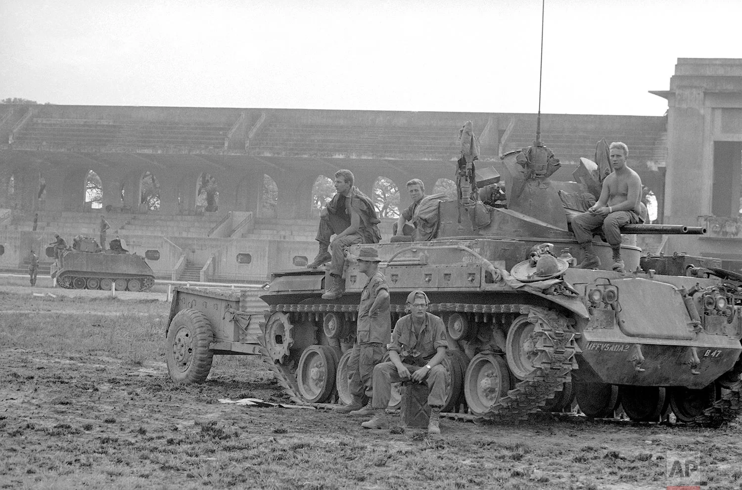 US soldiers rest on top of a tank at the Phu Tho racetrack in western Saigon, Feb. 8-26, 1968. US and S.Vietnamese troops set up a fire support base at the track to support troops engaged in mop-up operations throughout the city during the Tet Offensive. (AP Photo/Eddie Adams)