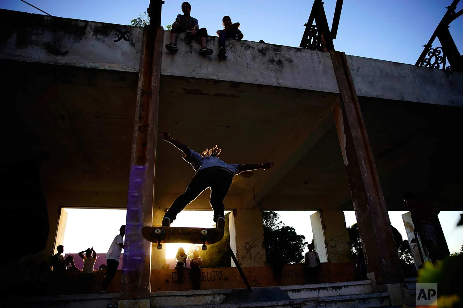 In this Jan. 11, 2018 photo, a skater jumps a ramp during the inauguration of a new recreational space for skateboarders, created in an abandoned gym at the Educational complex Ciudad Libertad, a former military barracks that the late Fidel Castro turned into a school complex after the revolution in Havana, Cuba. (AP Photo/Ramon Espinosa)