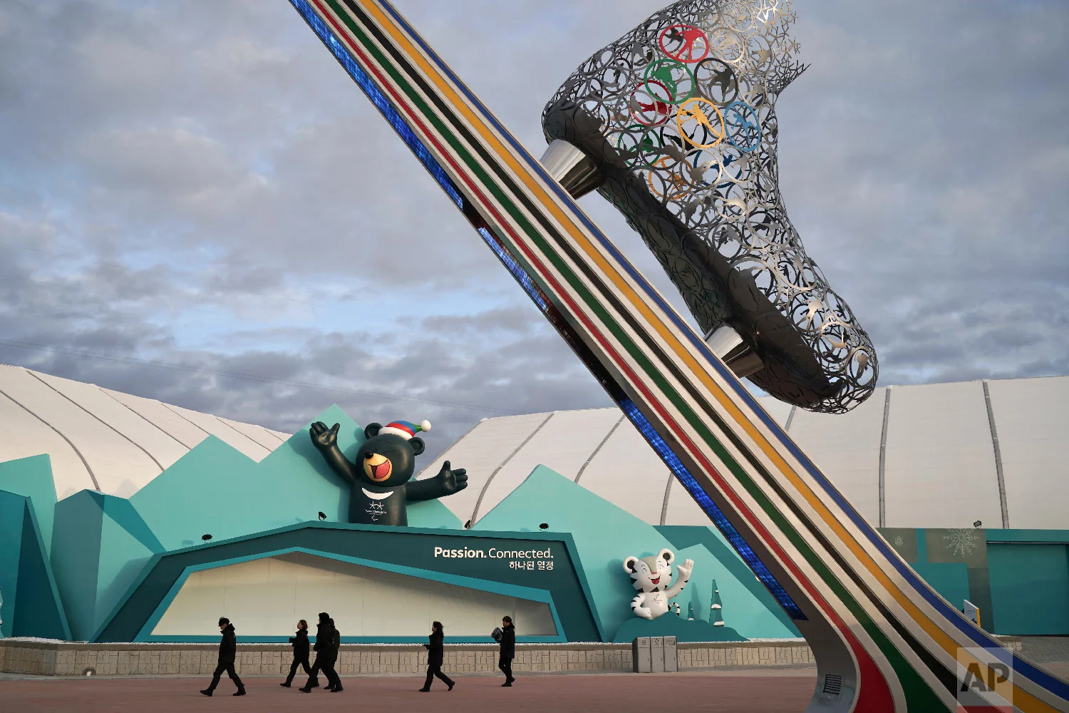 Security personnel walk at the Gangneung Olympic Park ahead of the 2018 Winter Olympics in Gangneung, South Korea, Friday, Feb. 2, 2018. The Gangneung coastal cluster is hosting the ice sports, including figure skating, speed skating, hockey and curling. (AP Photo/Felipe Dana)