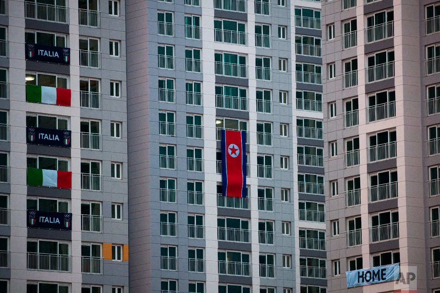 A large North Korean flag hangs from an apartment building at the Olympic Village prior to the 2018 Winter Olympics in Gangneung, South Korea, Friday, Feb. 2, 2018. (AP Photo/Jae C. Hong)