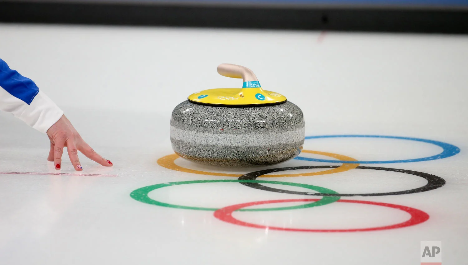 United States' Becca Hamilton throws a rock during a training session with her sibling and teammate Matt Hamilton ahead of the 2018 Winter Olympics in Gangneung, South Korea, Wednesday, Feb. 7, 2018. (AP Photo/Natacha Pisarenko)