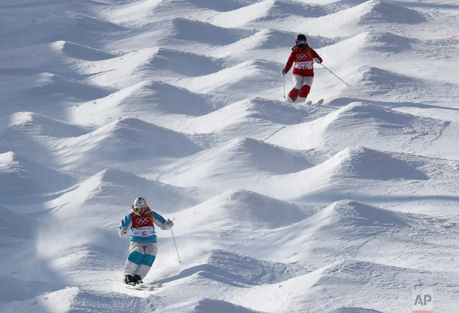 Yulia Galysheva, left, of Kazakhstan, and Jin Wang, of China, train ahead of the 2018 Winter Olympics in Pyeongchang, South Korea, Thursday, Feb. 8, 2018. (AP Photo/Lee Jin-man)