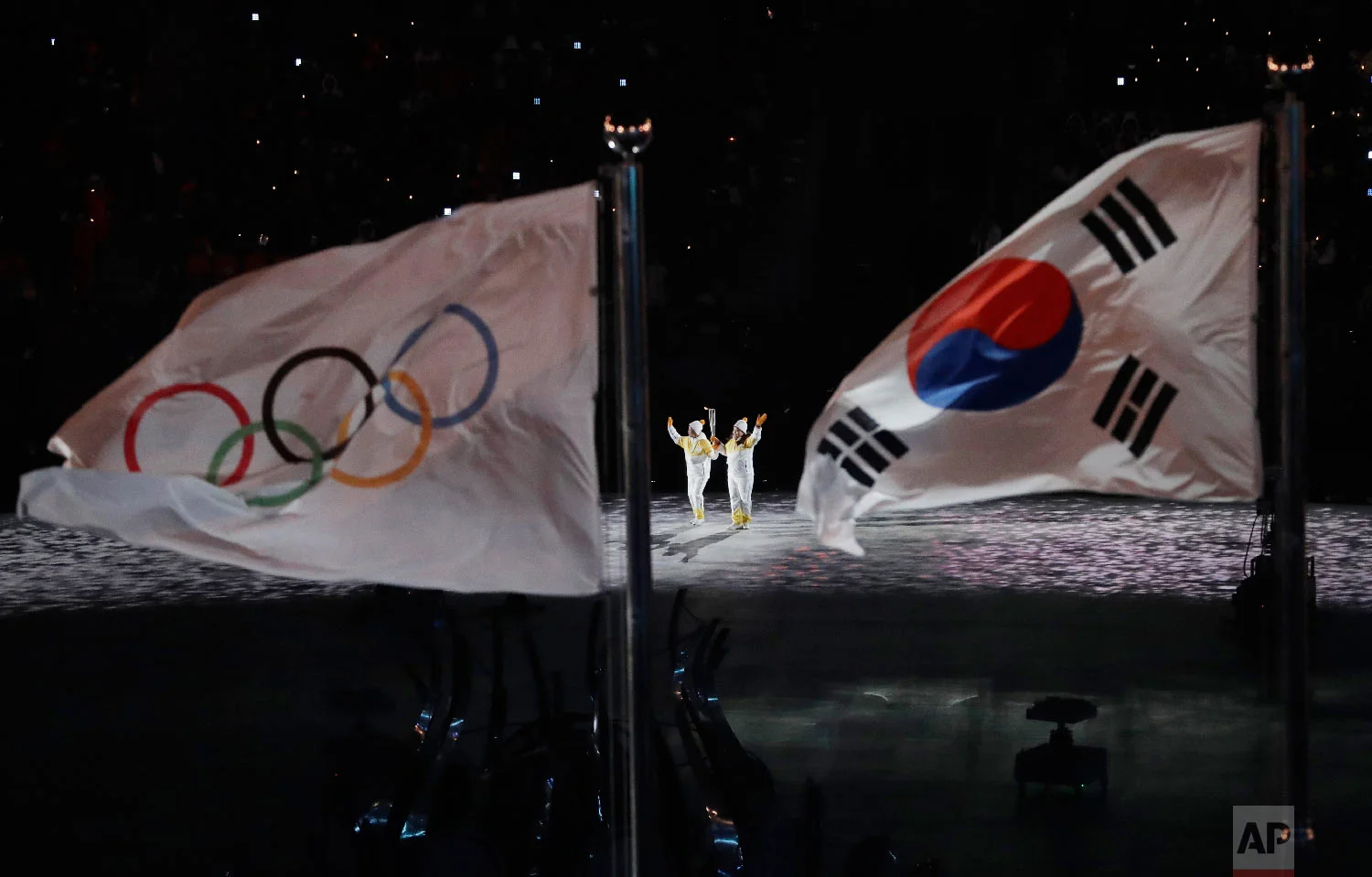 The Olympic torch is carried into the stadium during the opening ceremony of the 2018 Winter Olympics in Pyeongchang, South Korea, Friday, Feb. 9, 2018. (AP Photo/Matthias Schrader)