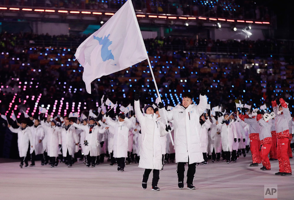  North Korea's Hwang Chung Gum and South Korea's Won Yun-jong arrive during the opening ceremony of the 2018 Winter Olympics in Pyeongchang, South Korea, Friday, Feb. 9, 2018. (AP Photo/Petr David Josek) 
