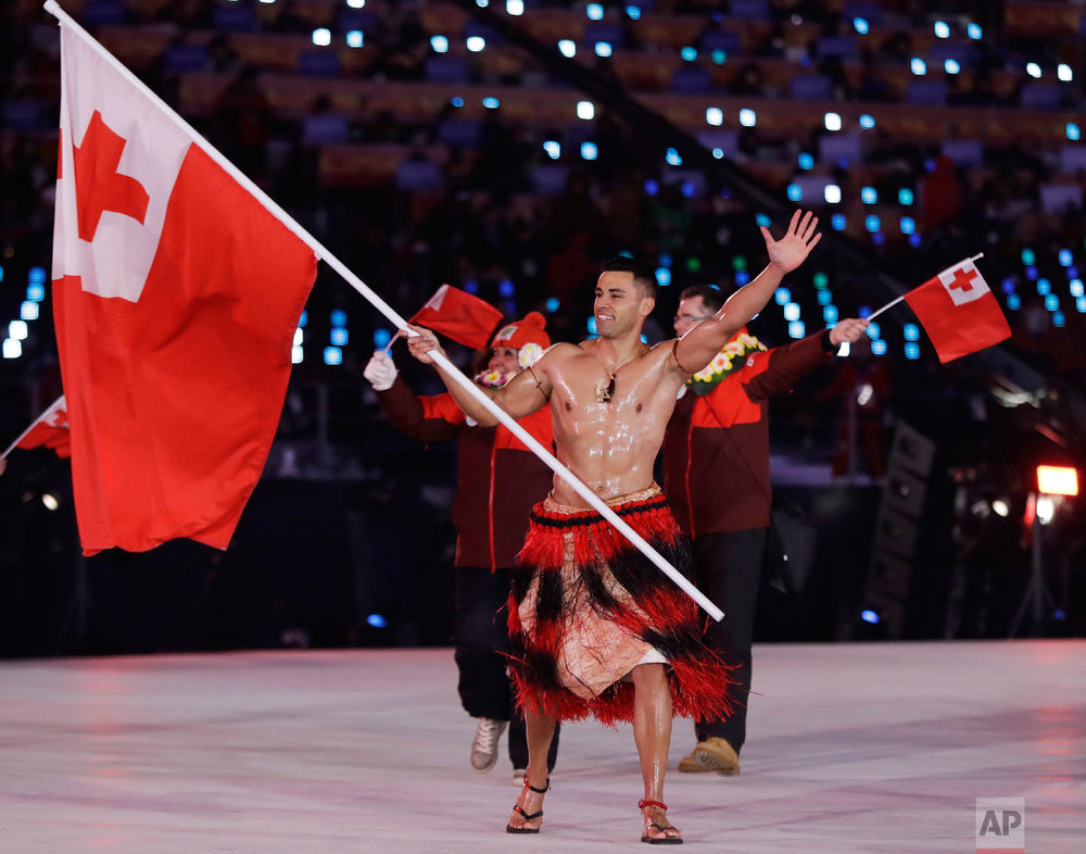  Pita Taufatofua carries the flag of Tonga during the opening ceremony of the 2018 Winter Olympics in Pyeongchang, South Korea, Friday, Feb. 9, 2018. (AP Photo/Petr David Josek) 