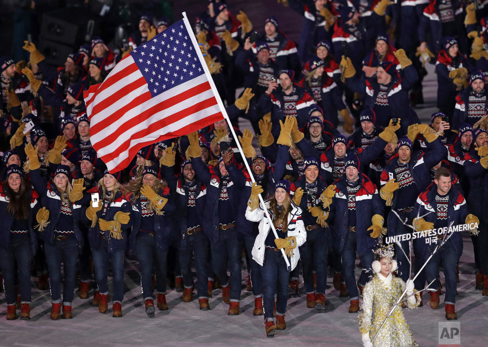  Erin Hamlin carries the flag of the United States during the opening ceremony of the 2018 Winter Olympics in Pyeongchang, South Korea, Friday, Feb. 9, 2018. (AP Photo/Michael Sohn) 
