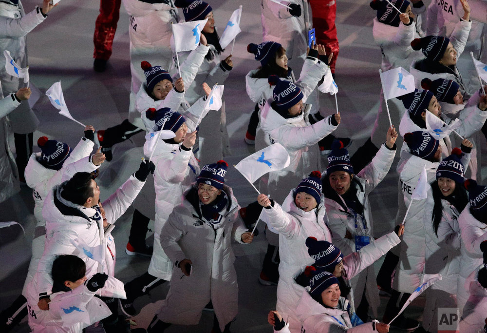  Athletes from North and South Korea wave Korean unification flags as they arrive during the opening ceremony of the 2018 Winter Olympics in Pyeongchang, South Korea, Friday, Feb. 9, 2018. (AP Photo/Charlie Riedel) 