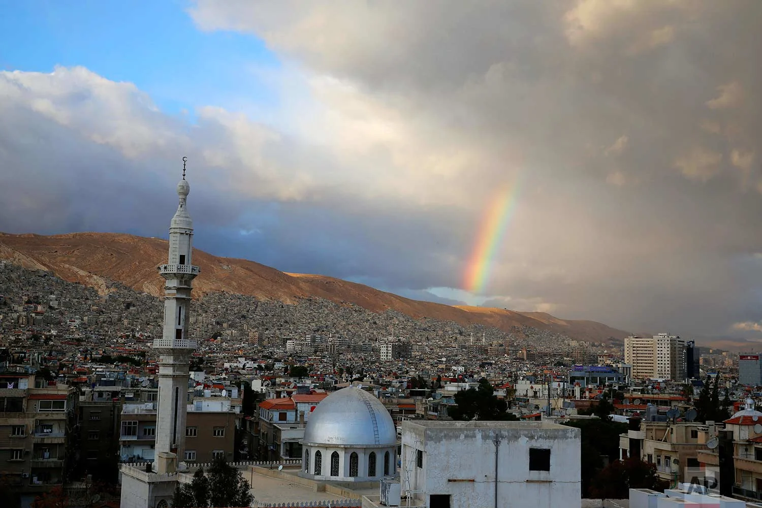 A rainbow appears over Damascus, Syria, Monday, Jan. 15, 2018. (AP Photo/Hassan Ammar)