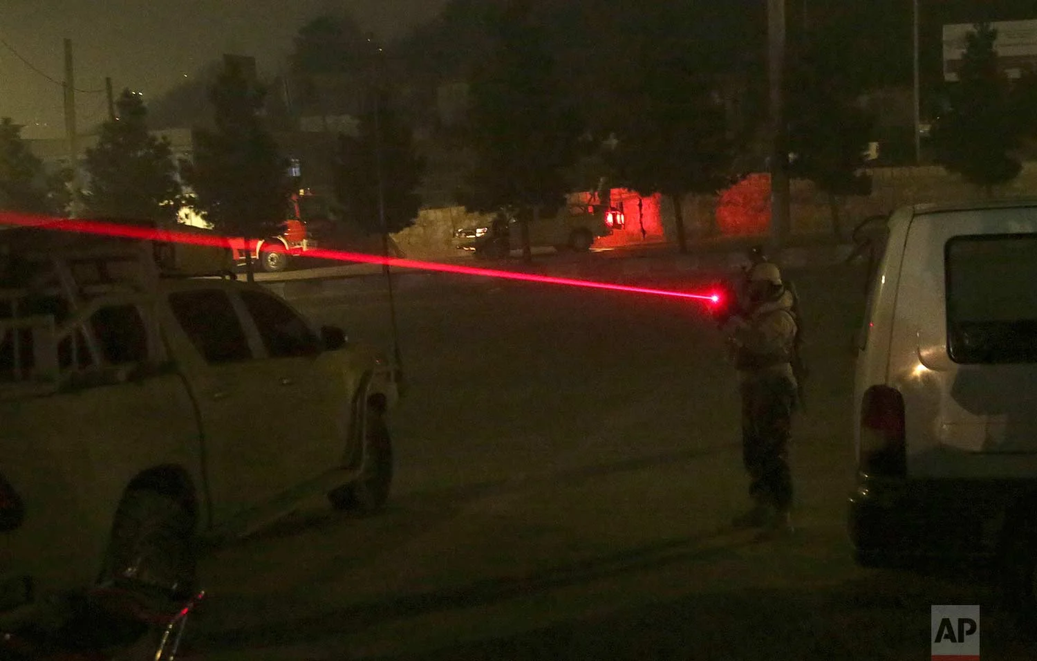 A security personnel points his weapon near the Intercontinental Hotel after a deadly attack in Kabul, Afghanistan, Saturday, Jan. 20, 2018. (AP Photo/Massoud Hossaini)