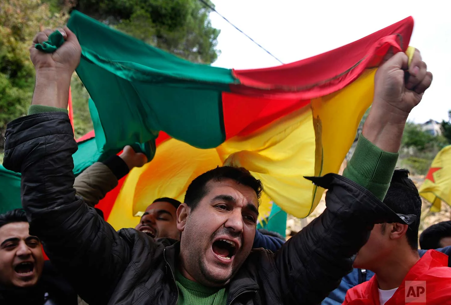 Kurdish demonstrators wave their national flag as they protest against the operation by the Turkish army aimed at ousting the U.S.-backed Kurdish militia from the area in Afrin, Syria, near the Turkish embassy, in Rabiyeh east of Beirut, Lebanon, Friday, Jan. 26, 2018. (AP Photo/Hussein Malla)