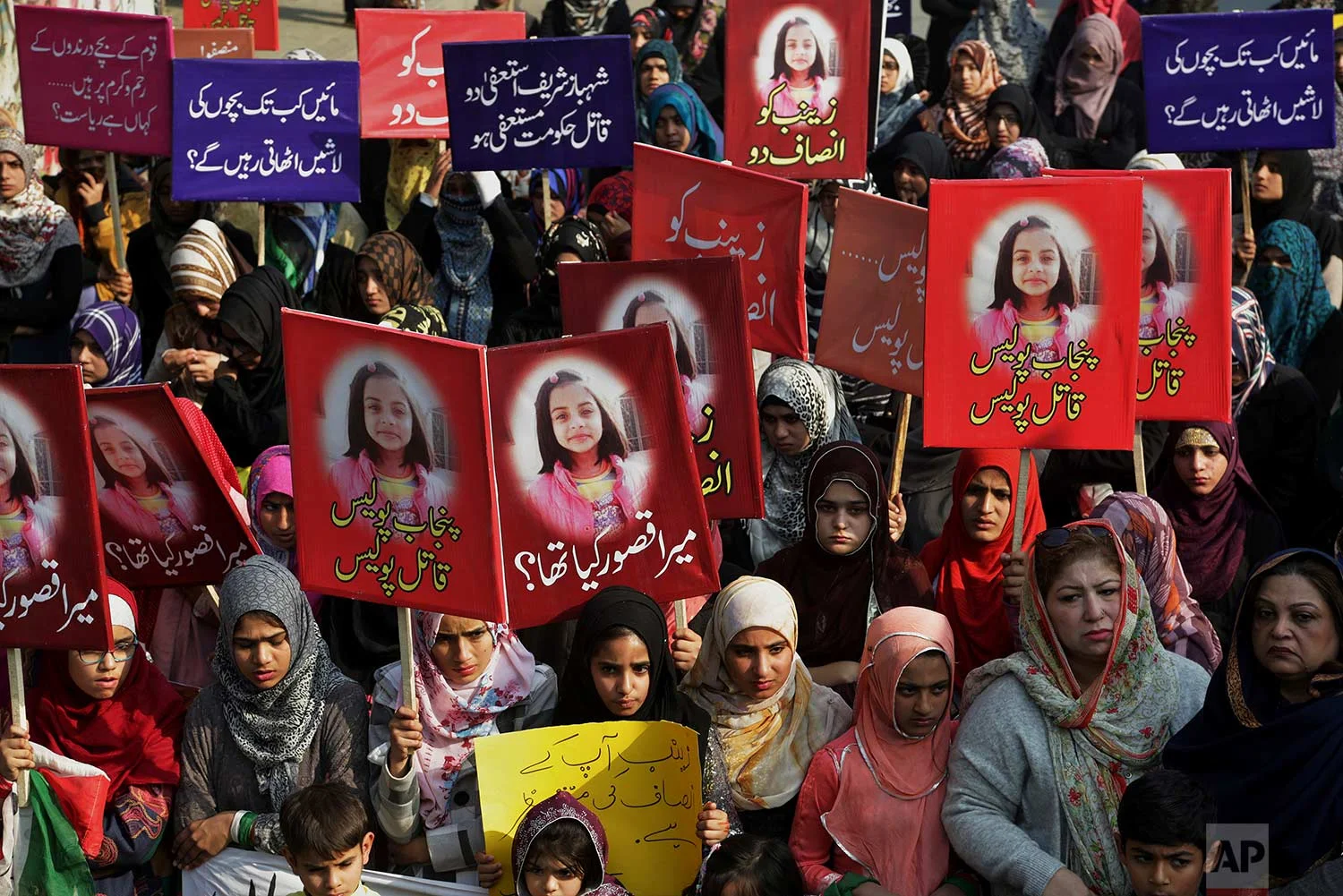 Supporters of Pakistan Awami Tehreek take part in a demonstration to condemn the brutal killing of Zainab Ansari, an 8-year-old girl, in Lahore, Pakistan, Saturday, Jan. 13, 2018. A Pakistani official says a serial killer may have been behind the rape and murder of the young girl which has sparked deadly clashes between protesters and police. (AP Photo/K.M. Chaudary)