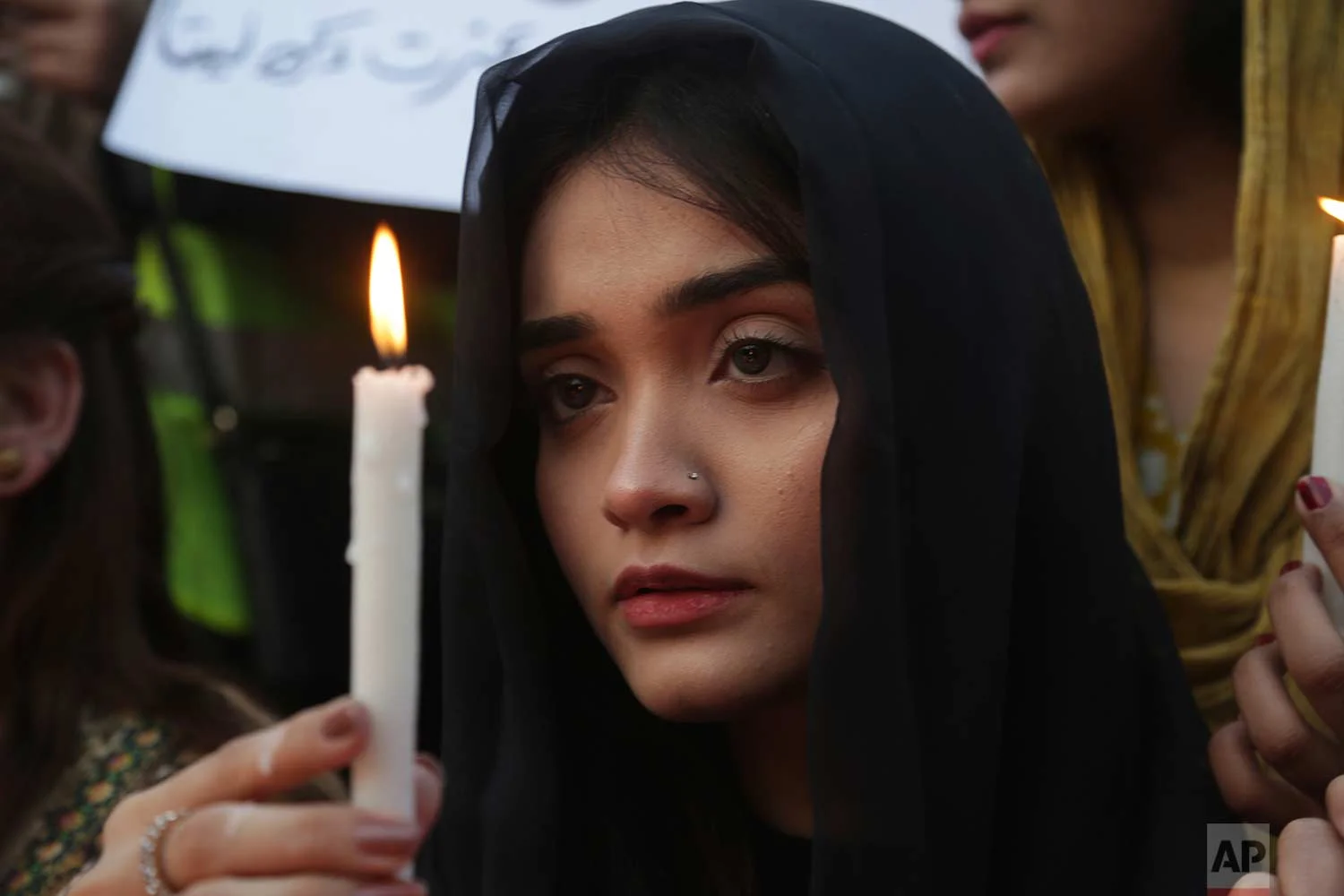 A Pakistani girl joins others during a memorial for Zainab Ansari, an 8-year-old girl who was kidnapped, raped and killed, in Lahore, Pakistan, Friday, Jan. 12, 2018. (AP Photo/K.M. Chaudary)