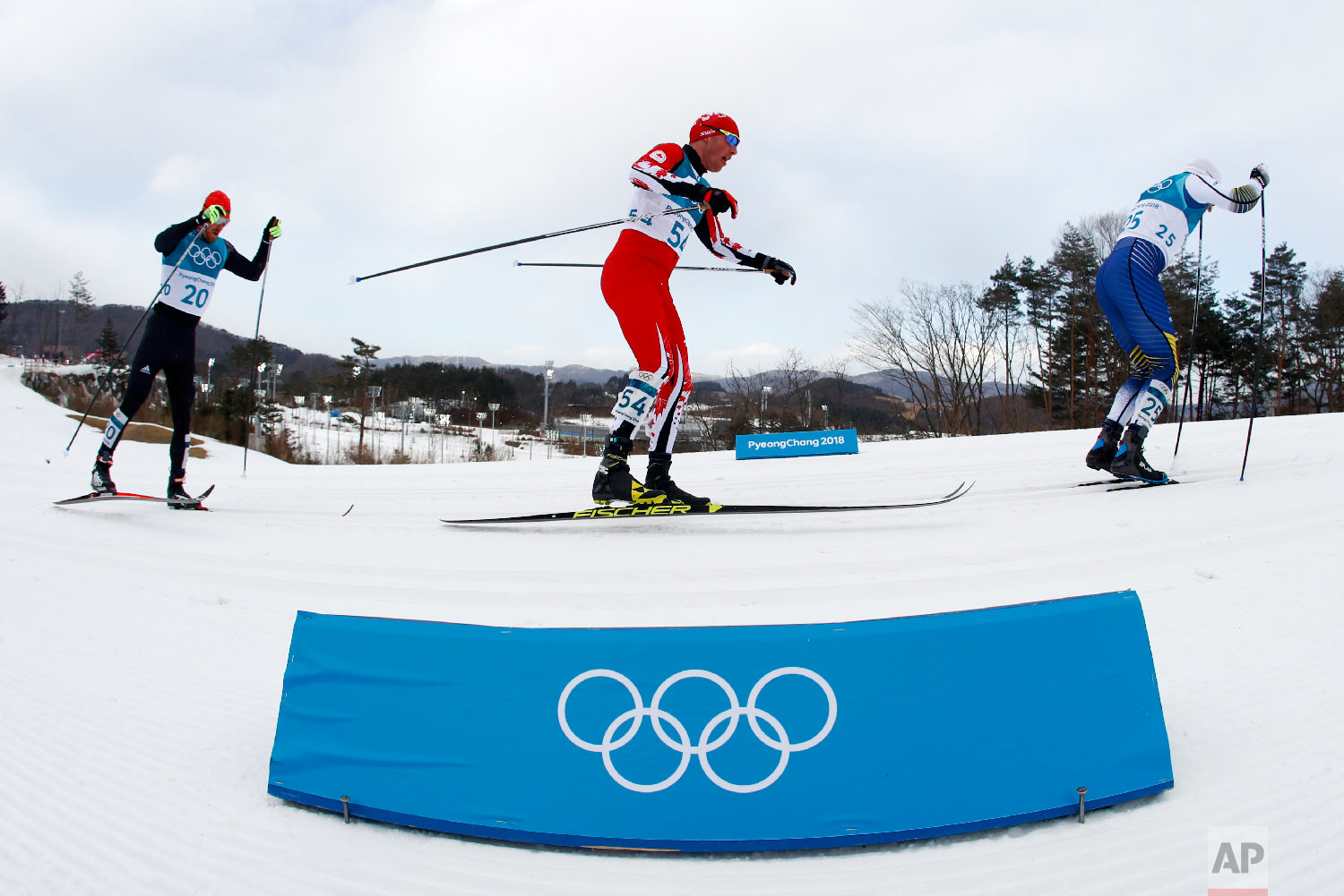  Skiers compete during the men's 15km/15km skiathlon cross-country skiing competition at the 2018 Winter Olympics in Pyeongchang, South Korea, Sunday, Feb. 11, 2018. (AP Photo/Matthias Schrader) 