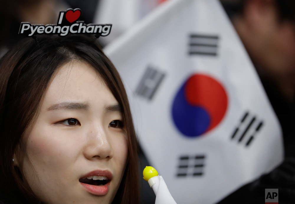  A South Korean fan watches her team play during a mixed double curling match against China at the 2018 Winter Olympics in Gangneung, South Korea, Thursday, Feb. 8, 2018. (AP Photo/Natacha Pisarenko) 