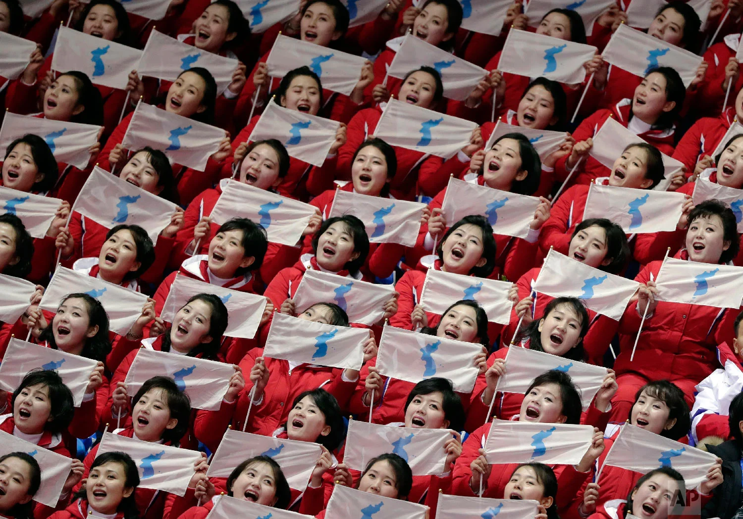North Korean supporters hold up Korean unification flags during the ladies' 500 meters short-track speedskating in the Gangneung Ice Arena at the 2018 Winter Olympics in Gangneung, South Korea, Saturday, Feb. 10, 2018. (AP Photo/Julie Jacobson)
