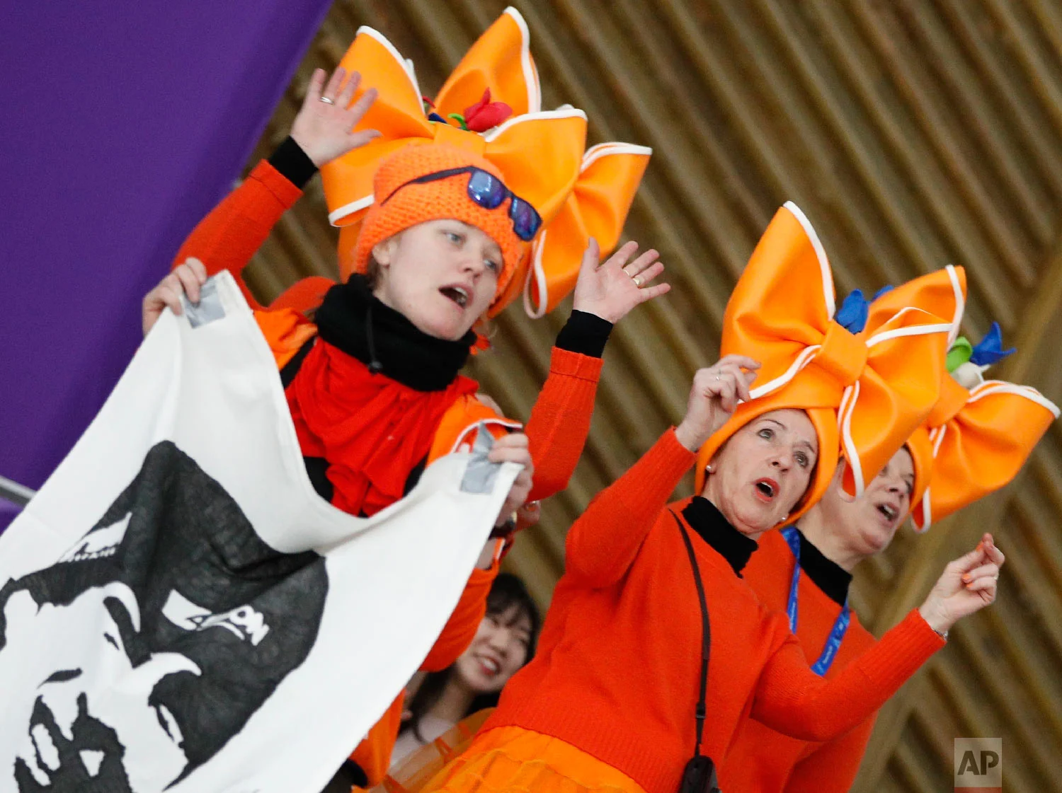 Fans clad in the colors of the Netherlands team hold a flag with the face of speed skater Sven Kramer of The Netherlands prior to the men's 5,000 meters race at the Gangneung Oval at the 2018 Winter Olympics in Gangneung, South Korea, Sunday, Feb. 11, 2018. (AP Photo/Vadim Ghirda)