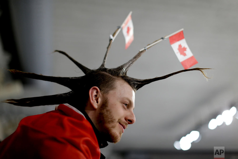  A spectator wearing the Canada flag on his hair watches the mixed doubles semi-final curling match between Russian athletes and Switzerland at the 2018 Winter Olympics in Gangneung, South Korea, Monday, Feb. 12, 2018. (AP Photo/Natacha Pisarenko) 