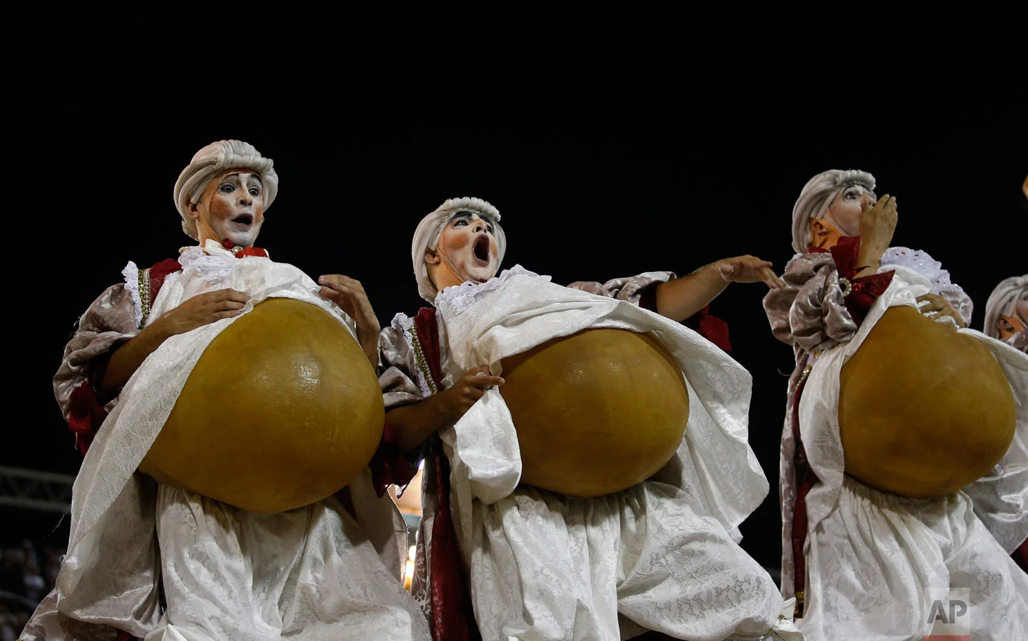 Performers from the Uniao da Ilha school parade on a float during Carnival celebrations at the Sambadrome in Rio de Janeiro, Brazil, early Tuesday, Feb. 13, 2018. (AP Photo/Silvia Izquierdo)