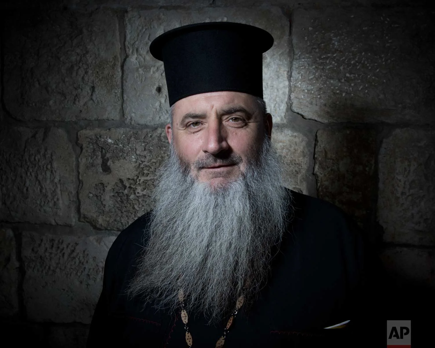 In this Sunday, Feb. 11, 2018 photo, Father Boris Manov poses for a portrait in Jerusalem's Old City. (AP Photo/Oded Balilty)